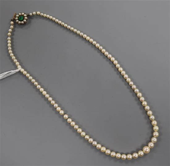 An early 20th century single strand graduated cultured pearl necklace, with green cabochon set clasp, approx 45cm.